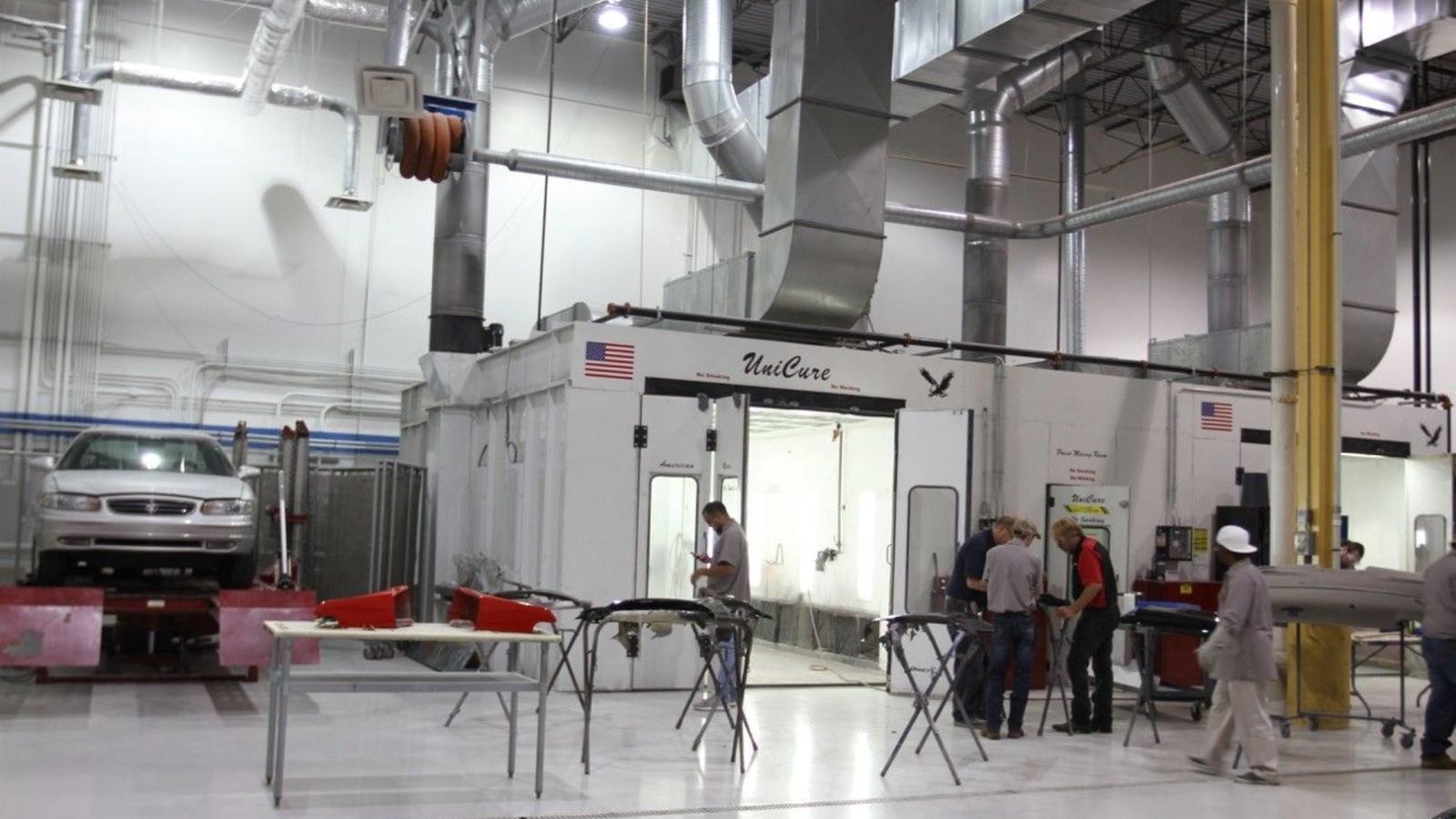 Collision students learn how an automotive paint booth filters air, controls dust and provides filtered air.