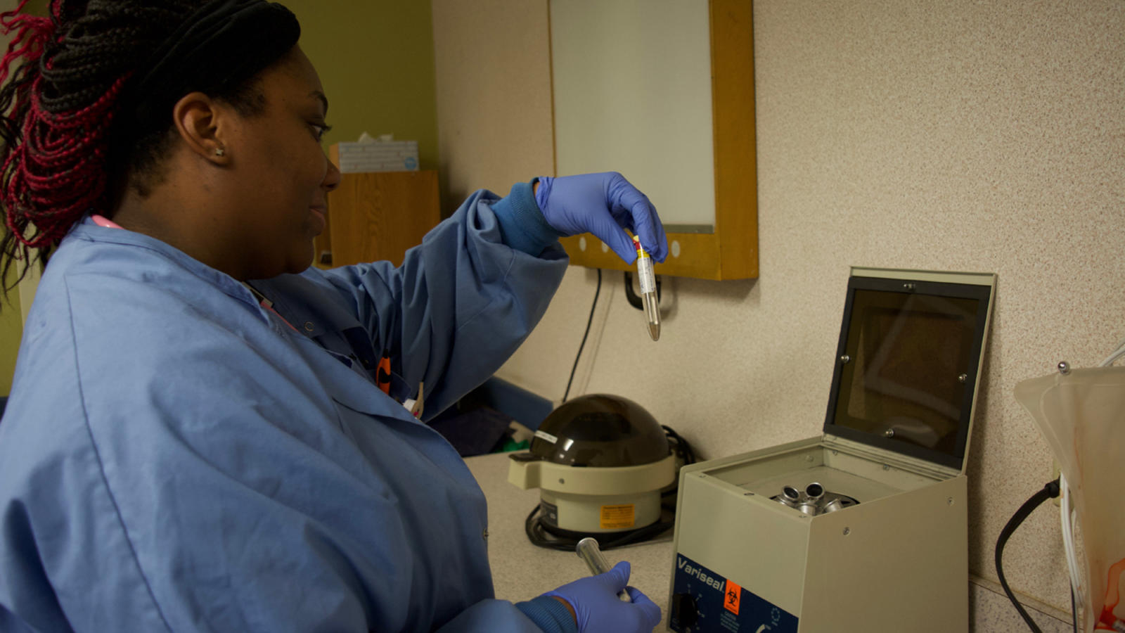 Students of the medical assistant program learn the use of the specimen centrifuge - a device that readies a sample for examination.