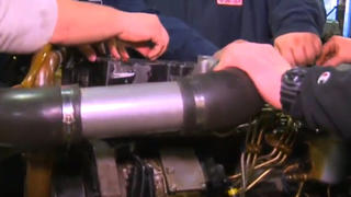 Indianapolis Diesel Students learn how to install a truck engine assembly.
