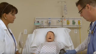 A nursing instructor teaches a practical nursing student care techniques.