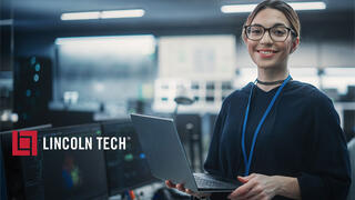 Computer support specialist working on laptop.