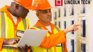 Two skilled tradesmen working on a maintenance project.