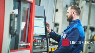 Journeyman machinist working on a CNC machine.