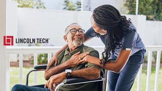 Medical assistant chats with patient at a clinic.