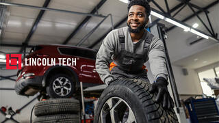 Auto mechanic at a tire machine