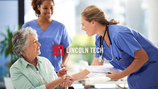 A medical assistant greets a patient at a treatment facility.
