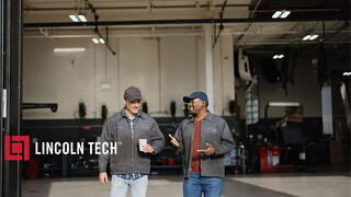 Two mechanics leaving a repair shop.