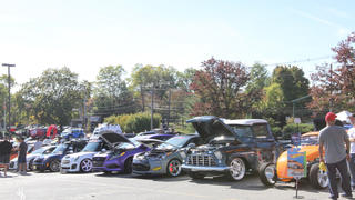 Image of cars lined up in a parking lot