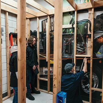 An electrical student in a simulated residential structure.