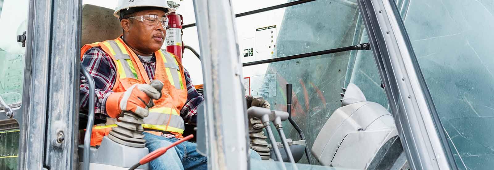 Heavy equipment operator using a backhoe