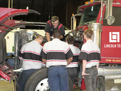 A diesel instructor teaches a group of student technicians proper diesel engine diagnosis