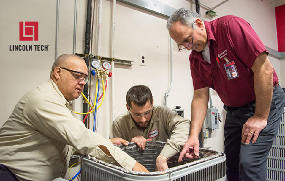 A master HVACR instructor oversees students working on an HVAC system.