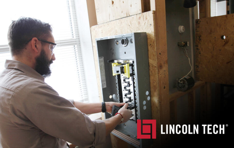 A Student in the Lincoln Tech Electrical Program Wires a Circuit Breaker Box