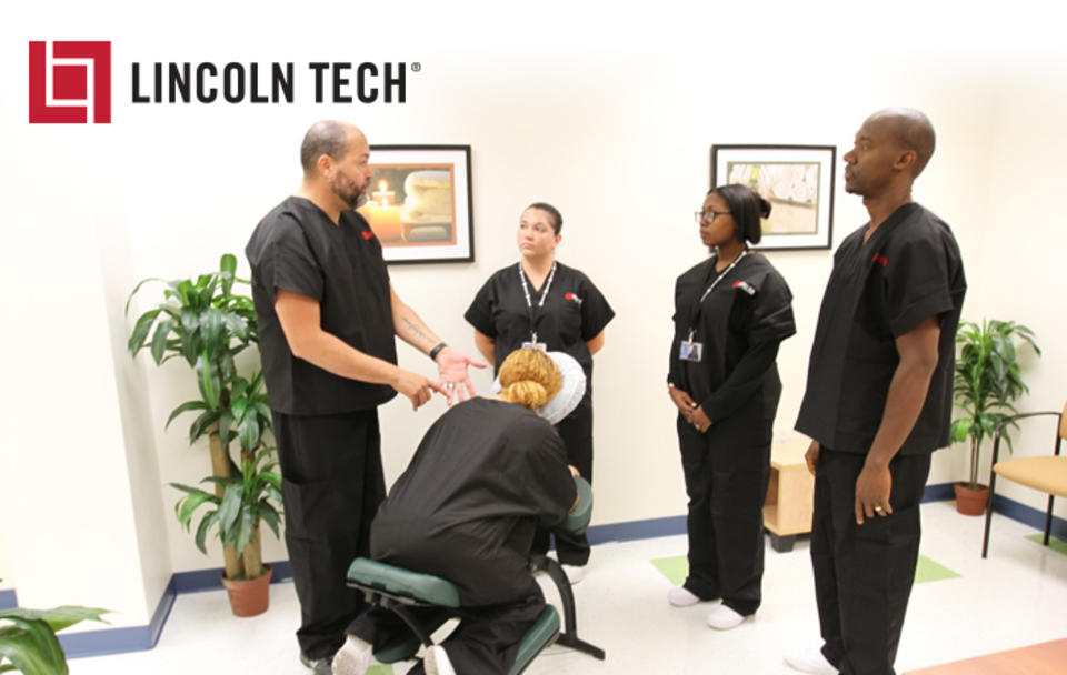 Students learn massage therapy techniques from a Lincoln Tech instructor