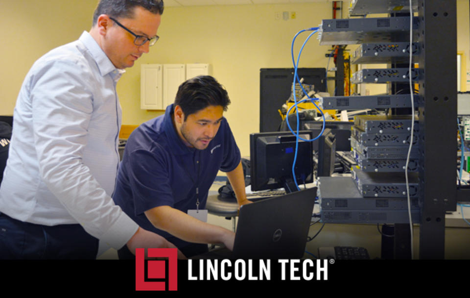 Two technicians working on a computer network.