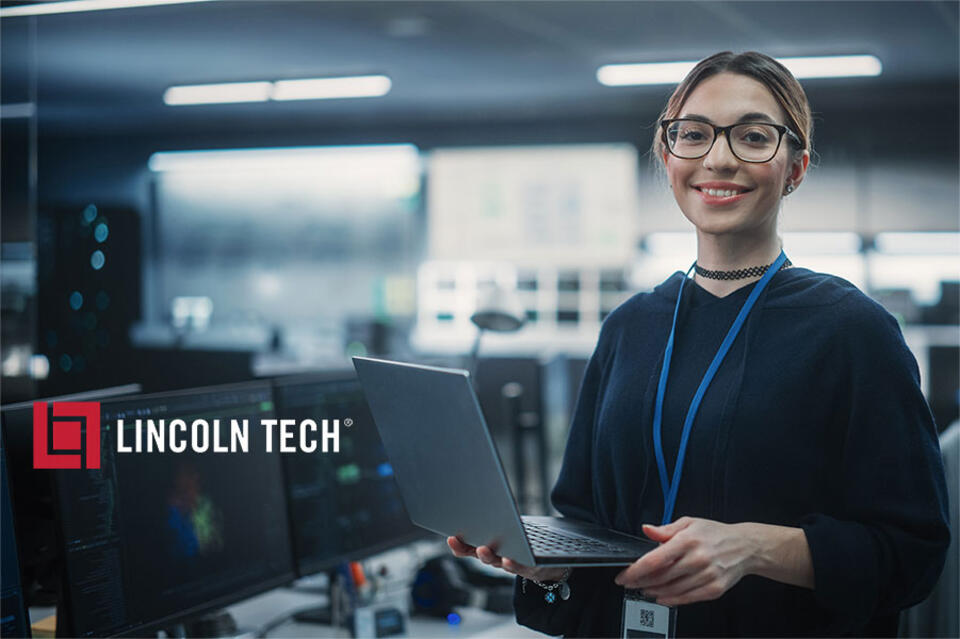 Computer support specialist working on laptop.