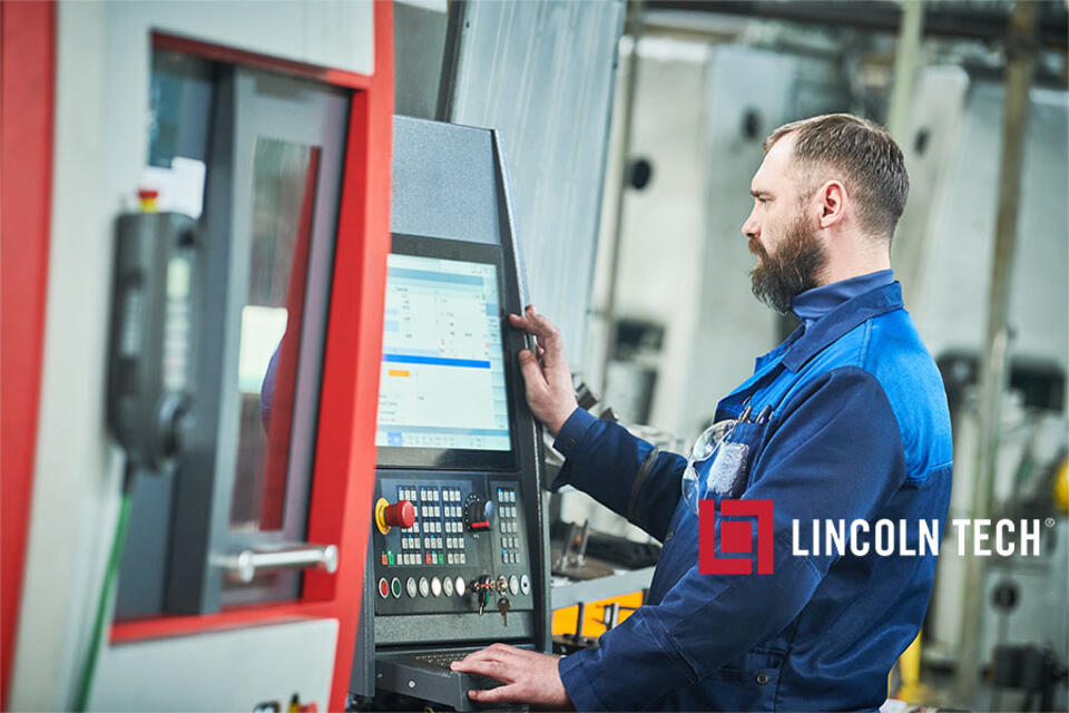 Journeyman machinist working on a CNC machine.