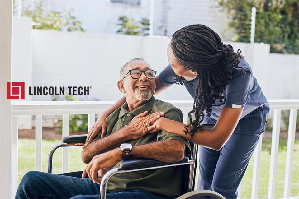 Medical assistant chats with patient at a clinic.