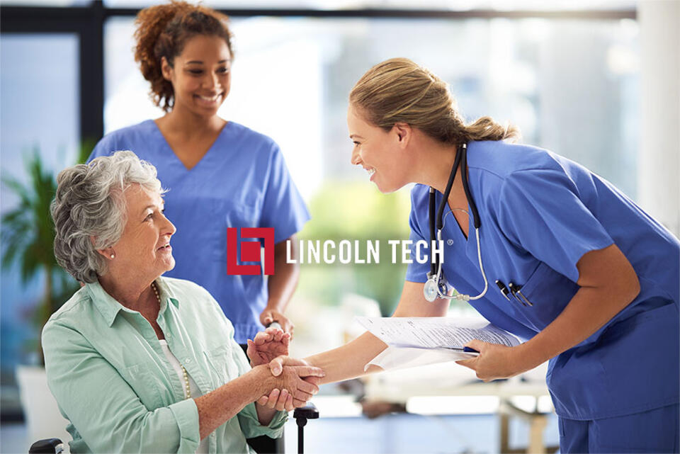 A medical assistant greets a patient at a treatment facility.